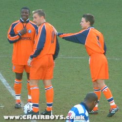 Sean Devine gets a pat on the back from Martyn Lee as he begins his first game since May 2000