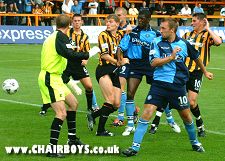 Sean Devine and Steve Brown watch Mark Rogers' header fly into the net