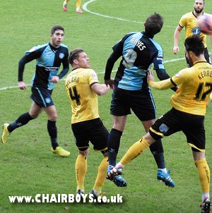 Wanderers Paul Hayes in an aeriel battle with Danny Bulman and Callum Kennedy