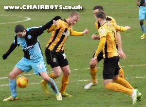 Hogan Ephraim - Wanderers match winner at Cambridge is surrounded by opponents at the Abbey Stadium