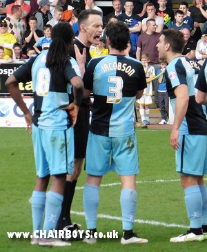 Wanderers players argue for a red card for hand ball