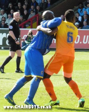 Aaron Pierre tussles with Adebayo Akinfenwa - Pierre was red carded later in the game