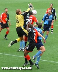 Rangers keeper Simon Royce struggles to get the ball away