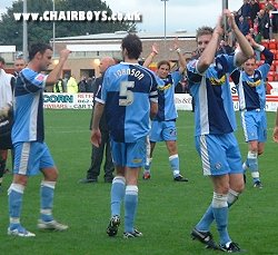 Wycombe players celebrate after the final whistle at Sincil Bank
