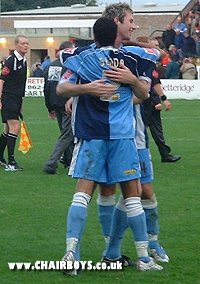 Two goal hero Mike Williamson celebrates with Danny Senda at Sincil Bank