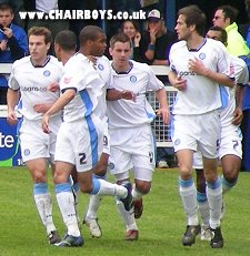 Wycombe players celebrate after Jermaine Easter opens scoring at Peterborough