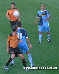 Andy Myers looks on as Ian Stonebridge shields the ball 