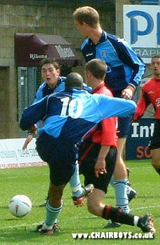 Nathaniel Griffiths gets in a shot as Andy Bell waits to convert