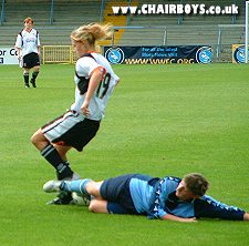 Nic Thorne slides in to win the ball
