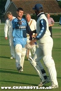 Jason Cousins and Steve Brown shake hands at the end of the cricket match